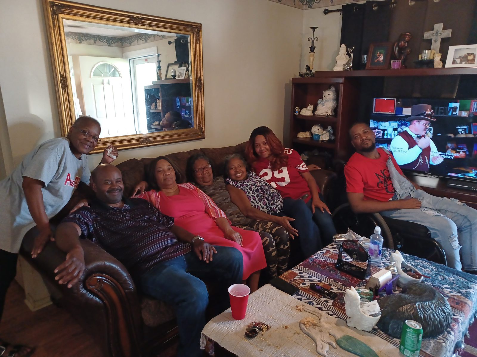 Lisa Ann Woods with family filling the living room of her home.